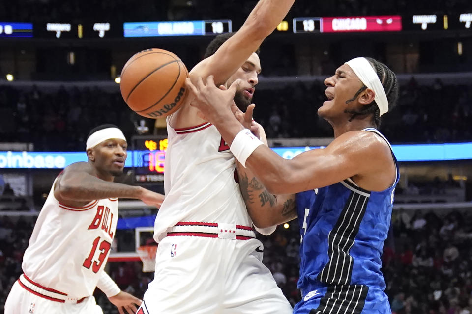 Orlando Magic's Paolo Banchero, right, is fouled by Chicago Bulls' Zach LaVine during the first half of an NBA basketball game Wednesday, Nov. 15, 2023, in Chicago. (AP Photo/Charles Rex Arbogast)