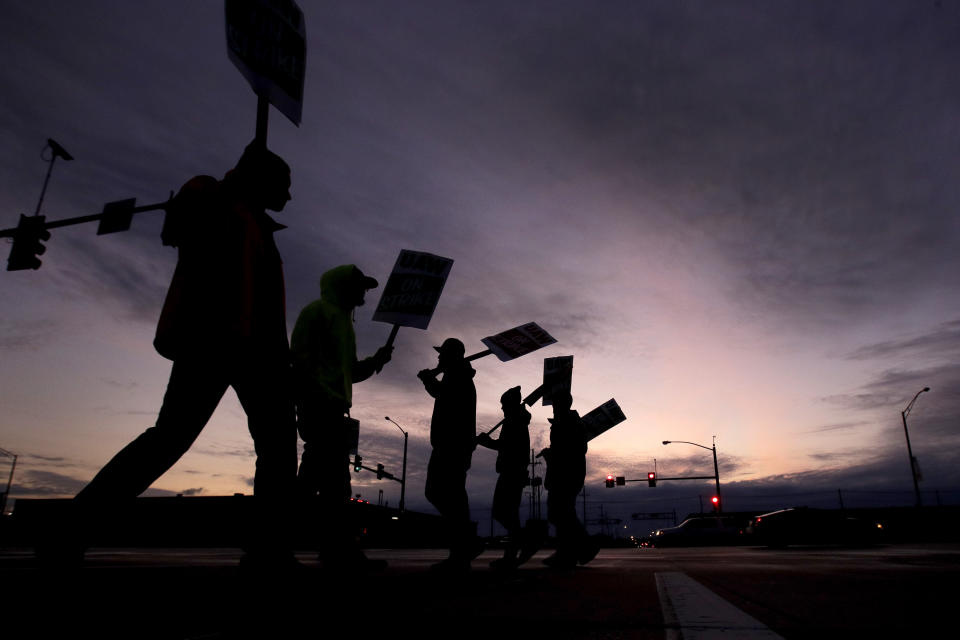 General Motors employees picket outside the Fairfax Assembly Plant in Kansas City, Kan. during the nationwide UAW strike against GM, Wednesday, Oct. 9, 2019. (AP Photo/Charlie Riedel)