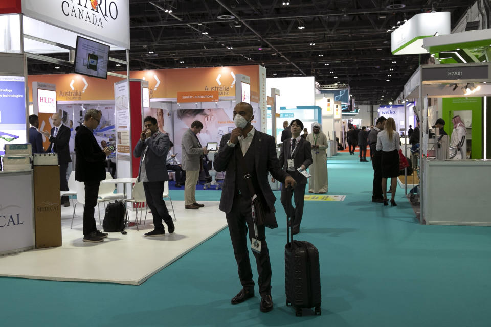 A visitor adjusts his mask as he walks at the Arab Health Exhibition in Dubai, United Arab Emirates, Wednesday, Jan. 29, 2020. The United Arab Emirates on Wednesday confirmed the first cases in the Mideast of the new Chinese virus that causes flu-like symptoms, saying doctors now were treating a family that had just come from a city at the epicenter of the outbreak. (AP Photo/Kamran Jebreili)