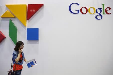 A woman walks past a logo of Google at the Global Mobile Internet Conference (GMIC) 2015 in Beijing, China, April 28, 2015. REUTERS/Kim Kyung-Hoon