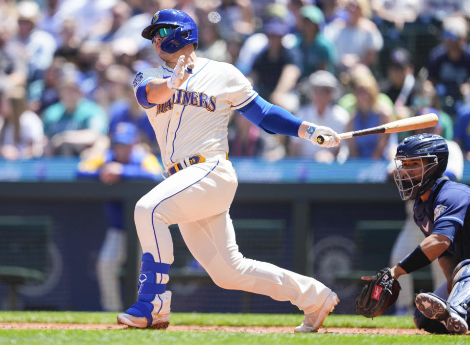 Seattle Mariners' Ty France follows through on an RBI double to score Julio Rodriguez against the Tampa Bay Rays during the third inning of a baseball game, Sunday, July 2, 2023, in Seattle. (AP Photo/Lindsey Wasson)