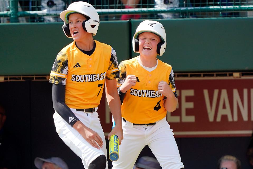Nolensville, Tenn.'s Lucas McCauley (7) and Turner Blalock (4) celebrate on the way back to the dugout after scoring on a base hit by Ty McKenzie II against Smithfield, R.I. during the first inning of a baseball game at the Little League World Series tournament in South Williamsport, Pa., Friday, Aug. 18, 2023. (AP Photo/Tom E. Puskar) ORG XMIT: PATP119