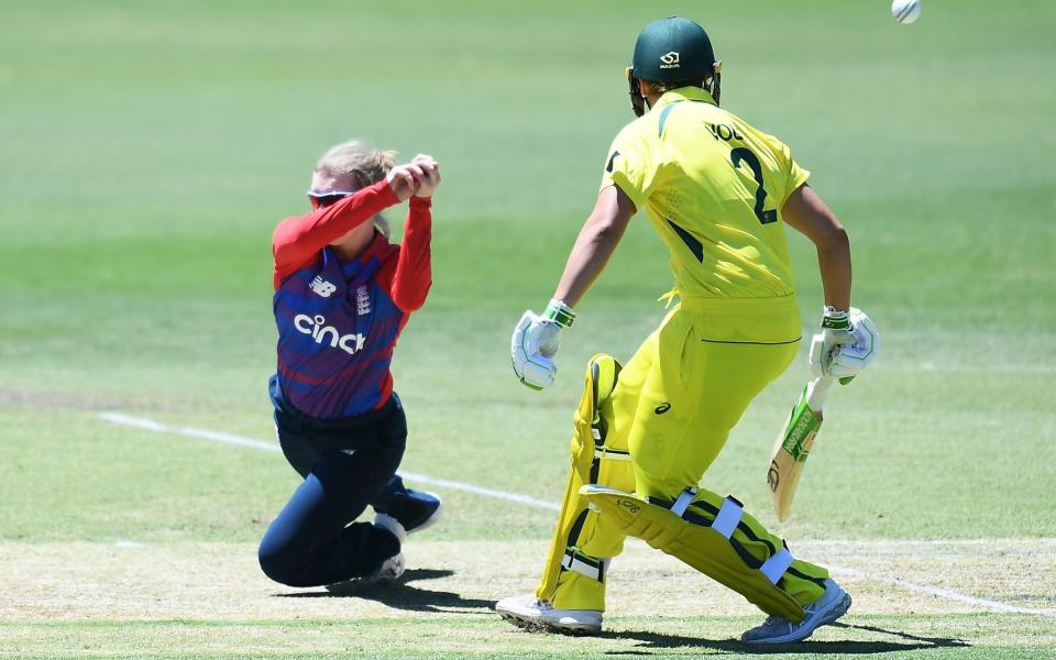 Charlie Dean of England is beaten by the ball off her bowling watched by Georgia Voll of Australia - Getty Images