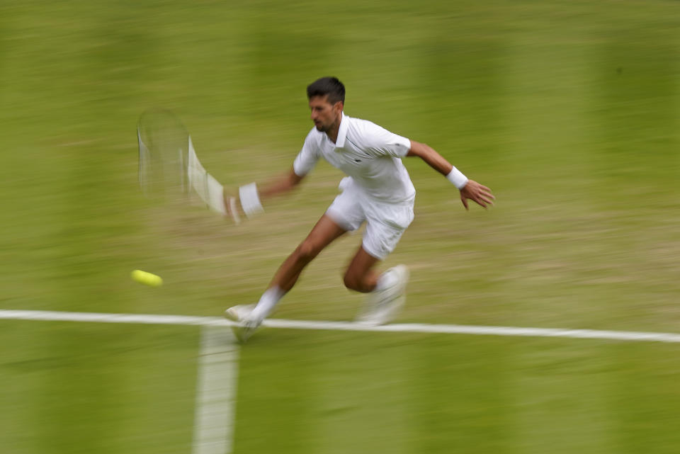 Serbia's Novak Djokovic returns to Italy's Jannik Sinner in a men's singles quarterfinal match on day nine of the Wimbledon tennis championships in London, Tuesday, July 5, 2022. (AP Photo/Alberto Pezzali)