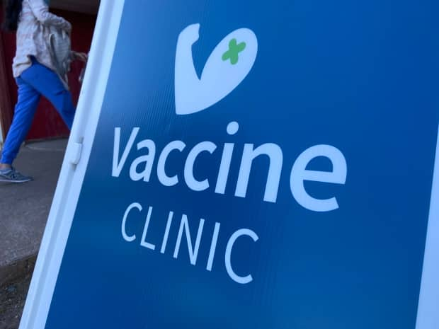 A health-care worker walks into a COVID-19 vaccine clinic. Nova Scotia reported 6 new cases of COVID-19 on Wednesday. (Frances Willick/CBC - image credit)