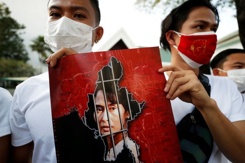 Myanmar citizens hold up a picture of leader Aung San Suu Kyi after the military seized power in a coup in Myanmar, outside United Nations venue in Bangkok