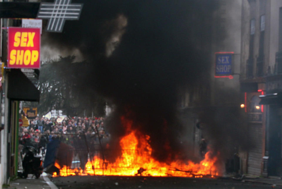 Demonstrators clash against French riot police during a demonstration in Nantes, Saturday Feb. 22, 2014, as part of a protest against a project to build an international airport, in Notre Dame des Landes, near Nantes. The project was decided in 2010 and the international airport should open by 2017. (AP Photo/ Laetitia Notarianni)