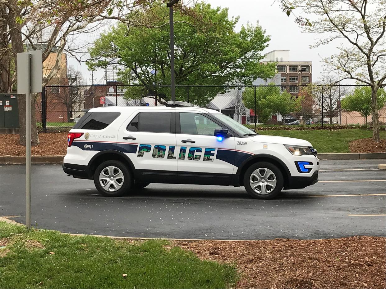 Police block off streets as they investigate the scene of a shooting otuside the Buncombe County Courthouse on March 31, 2020.