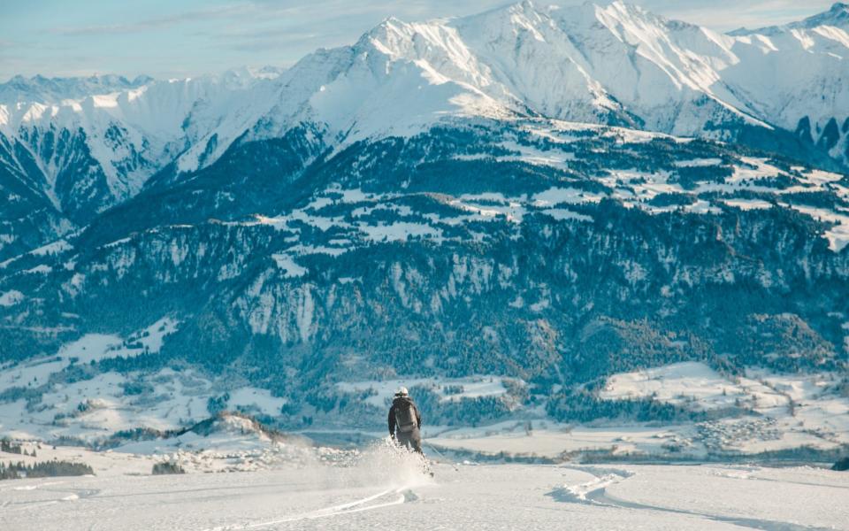 Woman skiing in Laax, Switzerland - Getty