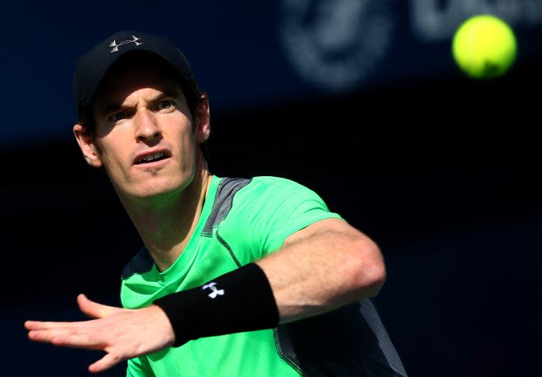 Great Britain's Andy Murray eyes the ball before returning it to Joao Sousa of Portugal during their match on the third day of the ATP Dubai Duty Free Tennis Championships on February 25, 2015