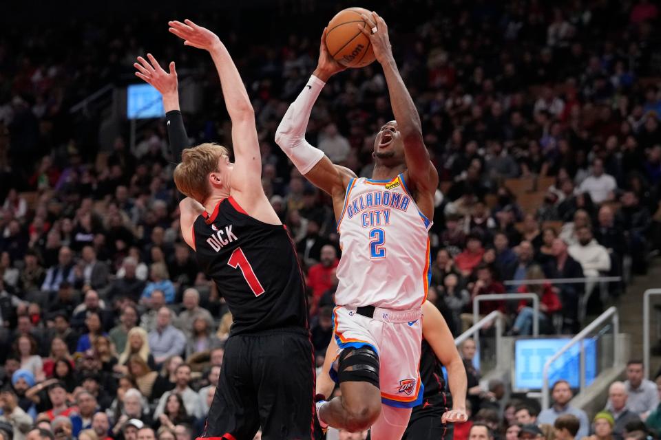 Thunder Shai Gilgeous-Alexander (2) goes up to make a basket as Raptors guard Gradey Dick (1) defends during the first half Friday night at Scotiabank Arena in Toronto.