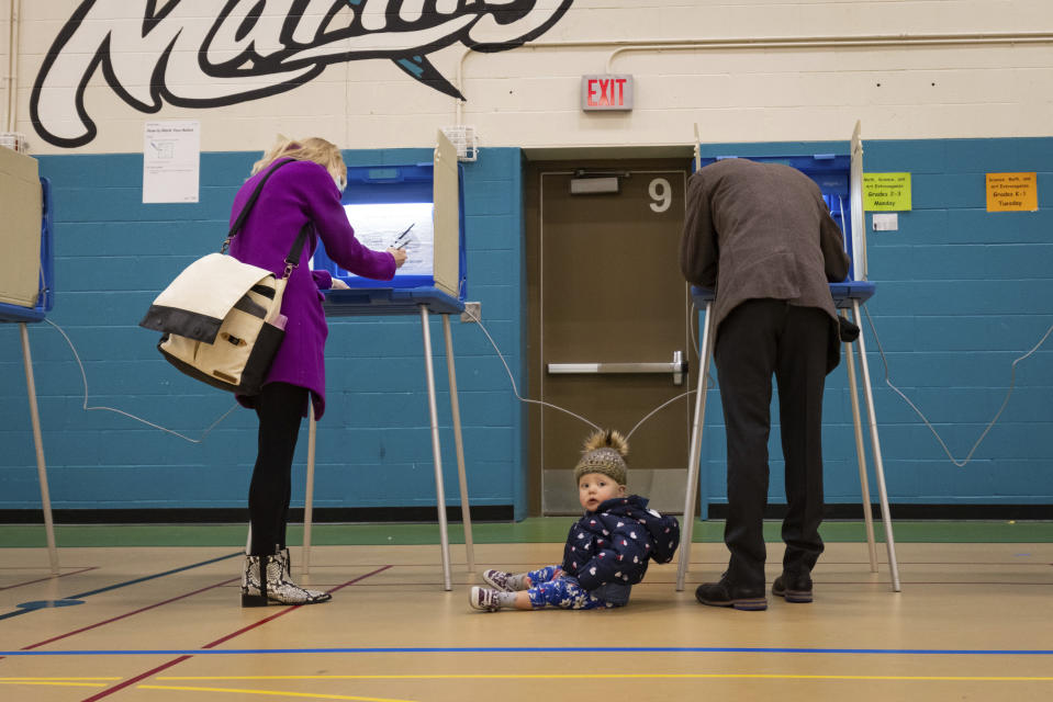 Mayor Jacob Frey casts his vote on Election Day alongside his family at the Marcy Arts Magnet Elementary School on Tuesday, Nov. 2, 2021 in Minneapolis. Voters in Minneapolis are deciding whether to replace the city’s police department with a new Department of Public Safety. The election comes more than a year after George Floyd’s death launched a movement to defund or abolish police across the country. (AP Photo/Christian Monterrosa)