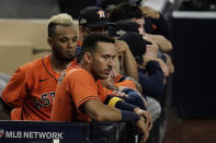 Houston Astros Carlos Correa watches the eighth inning from the dugout in Game 7 of a baseball American League Championship Series, Saturday, Oct. 17, 2020, in San Diego. (AP Photo/Gregory Bull)