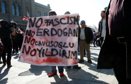 People hold banners and flags during a demonstration against Erdogan dictatorship and in favour of democracy in Turkey in Bern, Switzerland March 25, 2017. REUTERS/Ruben Sprich