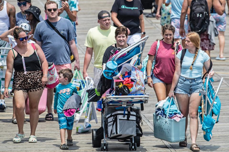 Families stroll the boardwalk in advance of the Rehoboth Beach Independence Day fireworks launch celebration on Sunday, July 2, 2023.