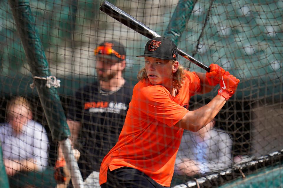 FILE- Jackson Holliday, the first overall draft pick by the Baltimore Orioles in the 2022 draft, takes batting practice with the team prior to a baseball game between the Orioles and the Tampa Bay Rays, Wednesday, July 27, 2022, in Baltimore. The Orioles have promoted top prospect Jackson Holliday to Triple-A Norfolk, another step in the 19-year-old shortstop's remarkable rise through the minors in his first full pro season. (AP Photo/Julio Cortez, File)
