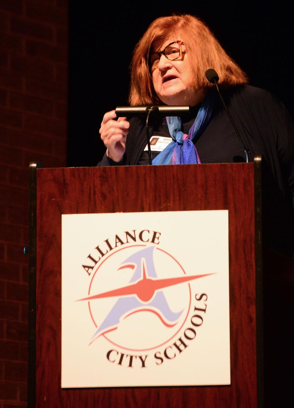 2023 Distinguished Alumni recipient Valerie Vanaman speaks during the induction ceremony on Monday, Oct. 2, 2023, in the Alliance High School auditorium.