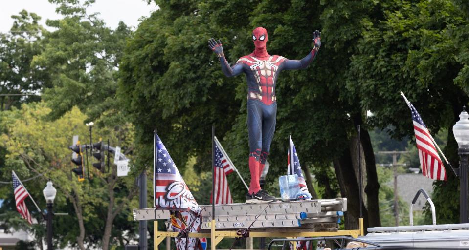 Spider-Man waves to the crowd Tuesday during 52nd annual North Canton Fourth of July Parade.