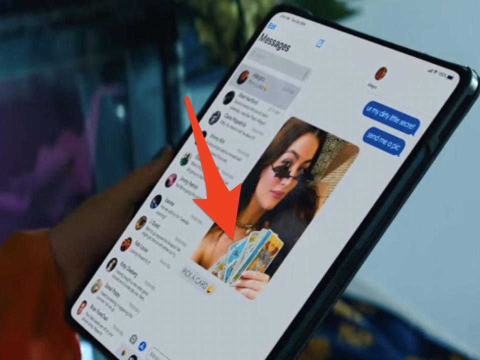 arrow pointing to allegra holding tarot cards in a photo she texted to Max