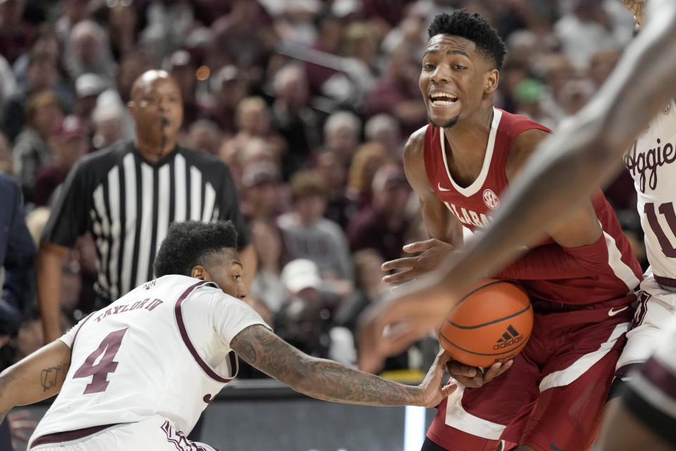 Alabama forward Brandon Miller (24) has the ball knocked away from him by Texas A&M guard Wade Taylor IV (4) while driving the lane during the first half of an NCAA college basketball game Saturday, March 4, 2023, in College Station, Texas. (AP Photo/Sam Craft)