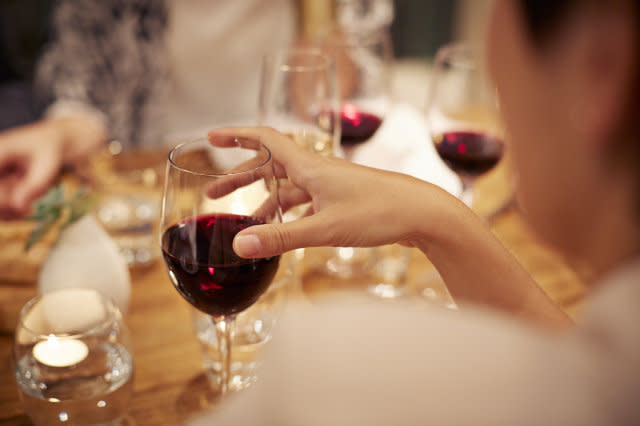 Close-up of female holding glass with redwine