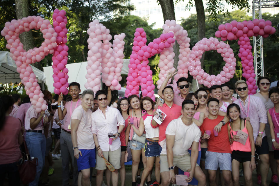 FILE - Thousands of people gathered at a park for the annual Pink Dot gay pride event on Saturday, July 1, 2017, in Singapore. Singapore’s announcement Sunday, Aug. 22, 2022, that it would decriminalize sex between men is being hailed as a step in the right direction for LGBTQ rights in the Asia-Pacific region, a vast area of nearly 5 billion people with different laws and attitudes. (AP Photo/Wong Maye-E, File)