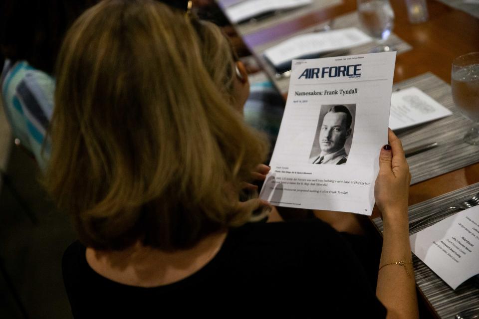 Family reads about WWI combat pilot Frank Tyndall as his medals are returned to his daughter, Mary Tyndall Troff, during a special presentation Tuesday, Aug. 16, 2022, at Seventy-Six Restaurant in Holland.