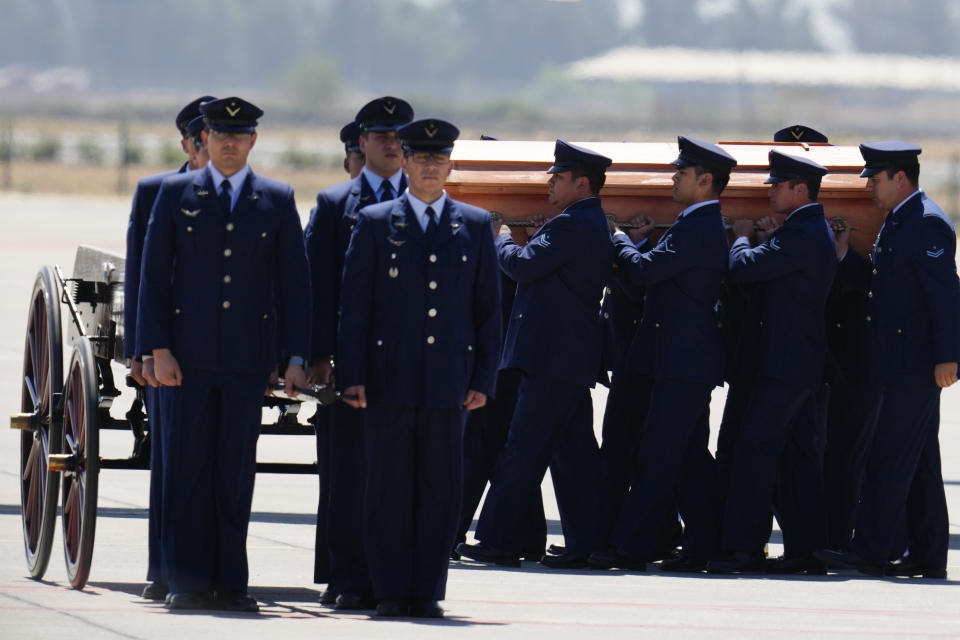 The remains of former Chilean President Sebastian Pinera arrive at the airport to be taken to Congress in Santiago, Chile, Wednesday, Feb. 7, 2024. The two-time former president died on Feb. 6 in a helicopter crash. He was 74. (AP Photo/Esteban Felix)