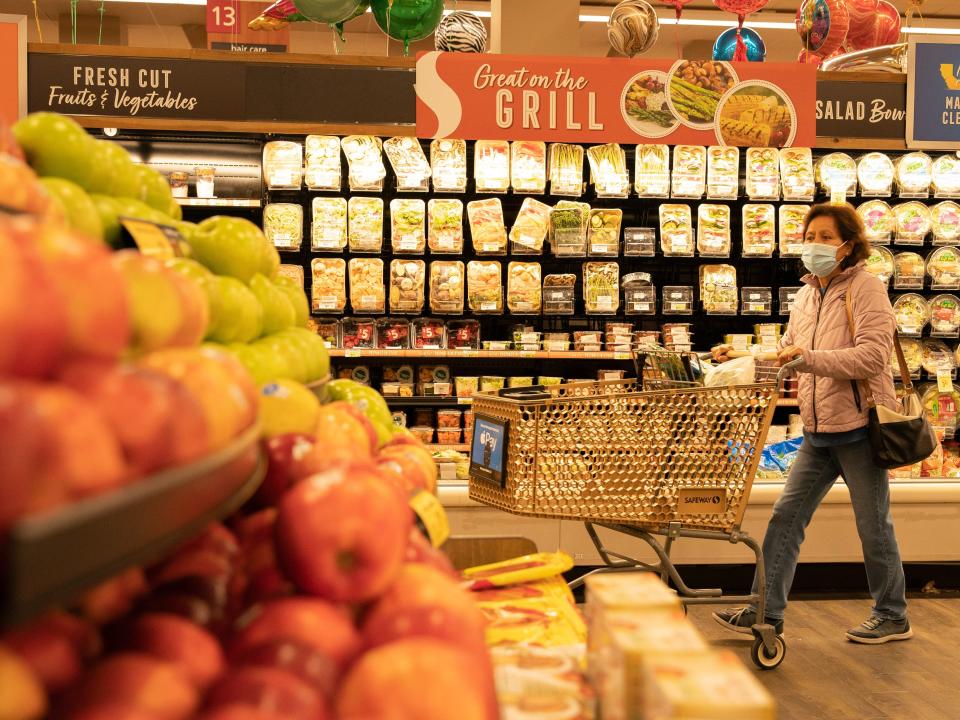 A woman shops for fruits at a supermarket.