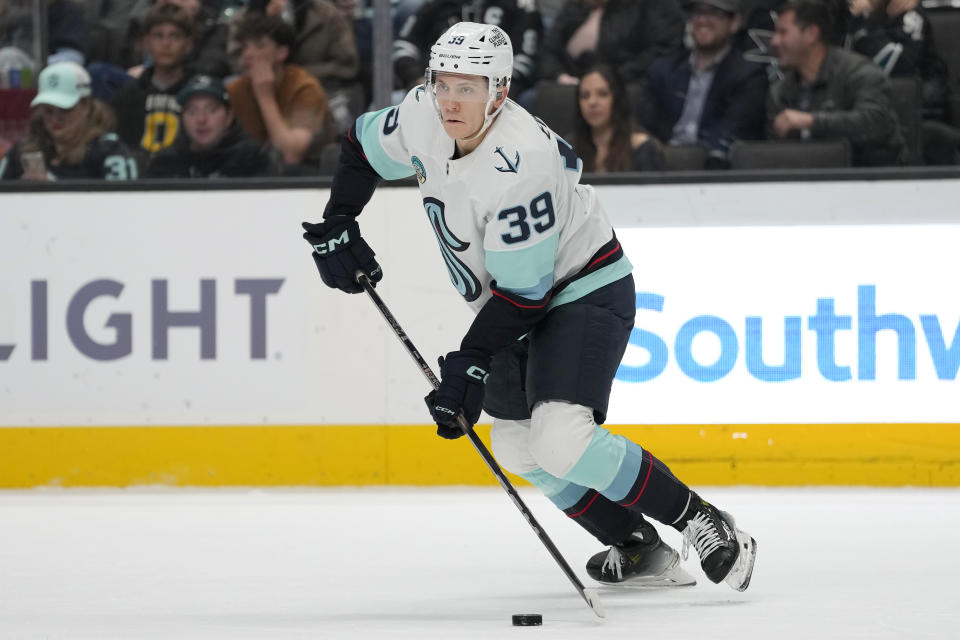 Seattle Kraken defenseman Ryker Evans (39) skates with the puck against the San Jose Sharks during the first period of an NHL hockey game in San Jose, Calif., Monday, April 1, 2024. (AP Photo/Jeff Chiu)