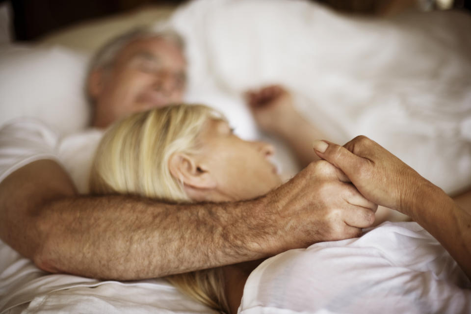 Man and woman in bed together. (Getty Images)