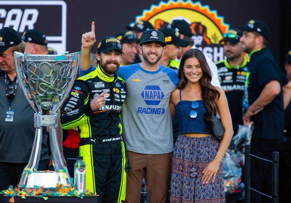 NASCAR Cup Series driver Ryan Blaney (left) celebrates with Chase Elliott (center) and Gianna Tulio after winning the 2023 NASCAR Cup Series Championship at Phoenix Raceway.