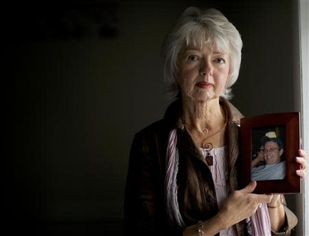 Terri Roberts, the mother of Amish school shooter Charles Roberts, holds a photograph of her son at New Covenant Community Church in Delta, Pennsylvania December 1, 2013. REUTERS/Mark Makela