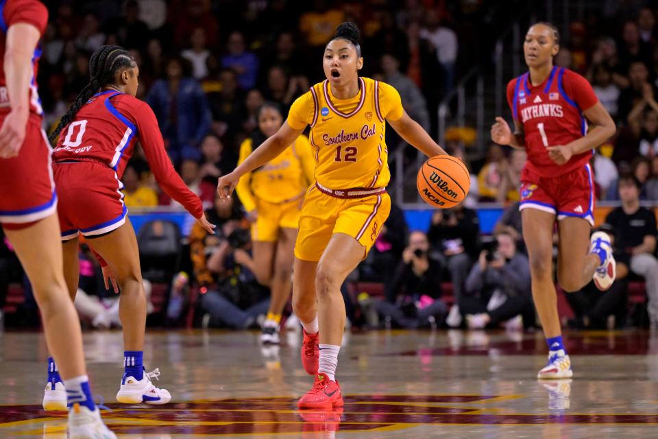 LOS ANGELES, CALIFORNIA - MARCH 25: JuJu Watkins #12 of the USC Trojans is defended by Wyvette Mayberry #0 of the Kansas Jayhawks as she takes the ball down court in the first half of the NCAA Women's Basketball Tournament game at Galen Center on March 25, 2024 in Los Angeles, California. (Photo by Jayne Kamin-Oncea/Getty Images)