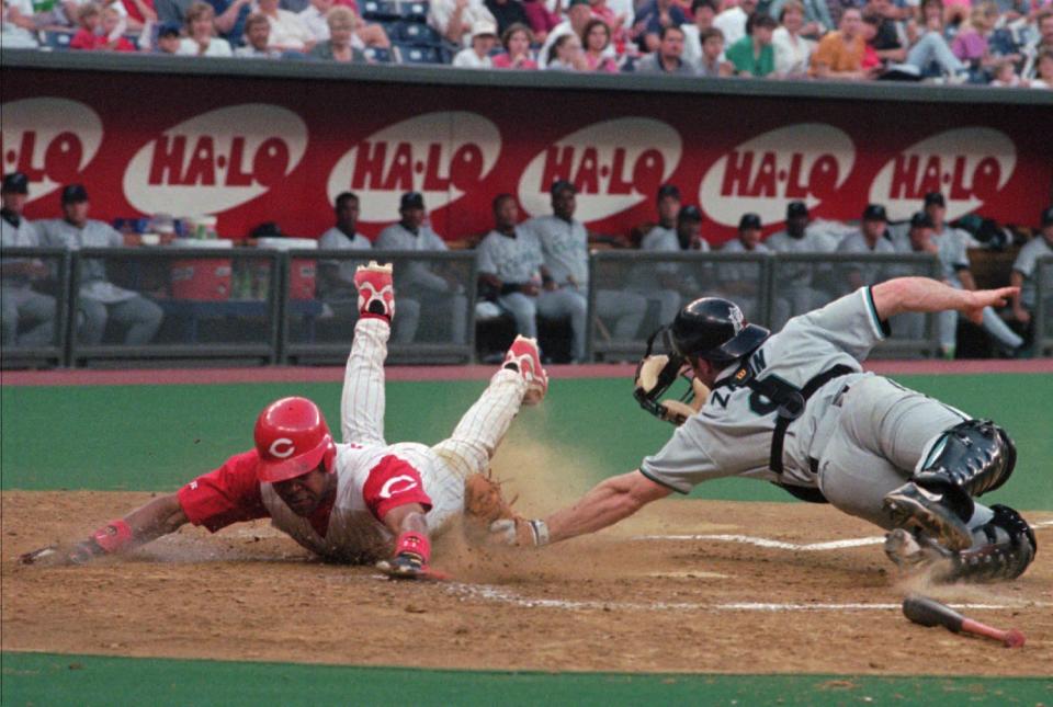 Cincinnati Reds' Barry Larkin is safe at home as Florida Marlins catcher Gregg Zaun makes the late tag May 14, 1998, in Cincinnati. (AP Photo/David Kohl)