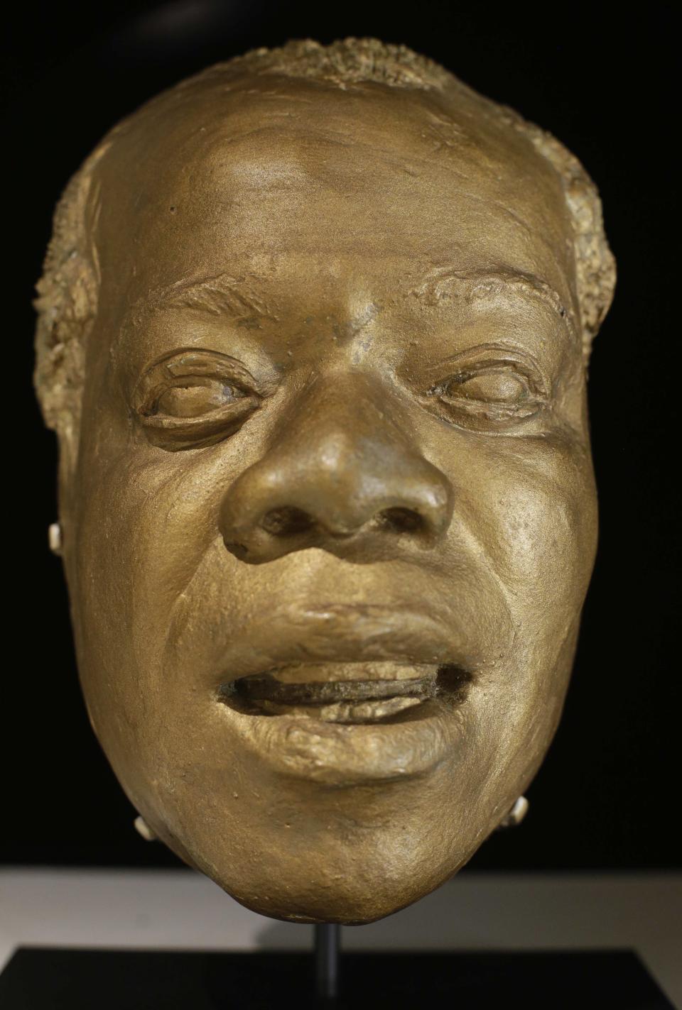 Louis Armstrong's life mask appears on display at the Louis Armstrong House Museum, Wednesday, Oct. 9, 2013, in the Queens borough of New York. To mark the 10th anniversary of the Louis Armstrong museum in the modest brick house where he lived for 28 years, curators are unveiling one of the jazz trumpeter's most unusual artifacts, on Tuesday, Oct. 15, 2013, the plaster mask that had been stored in a cupboard for decades. (AP Photo/Frank Franklin II)
