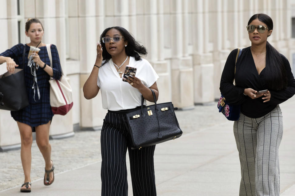 Azriel Clary, center, and Joycelyn Savage, right, two women who lived in Chicago with R&B singer R. Kelly, arrive at Brooklyn federal court for his arraignment, Friday, Aug. 2, 2019 in New York. Kelly faces charges he sexually abused women and girls. (AP Photo/Mark Lennihan)
