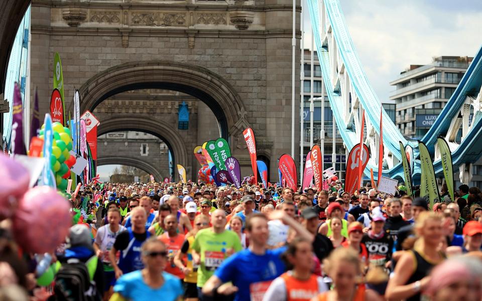 Runners cross Tower Bridge during the London Marathon