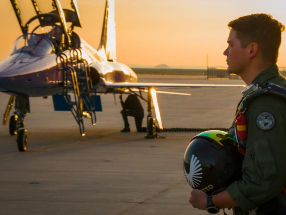 Brandenburg standing in front of the purple T-38 at dawn.