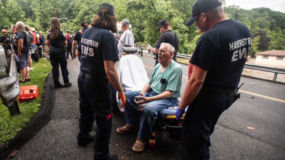 Emergency personnel tend to a resident in Stony Point, New York, after rescuing the man from his flooded home Sunday. - Seth Harrison/The Journal News/USA Today Network