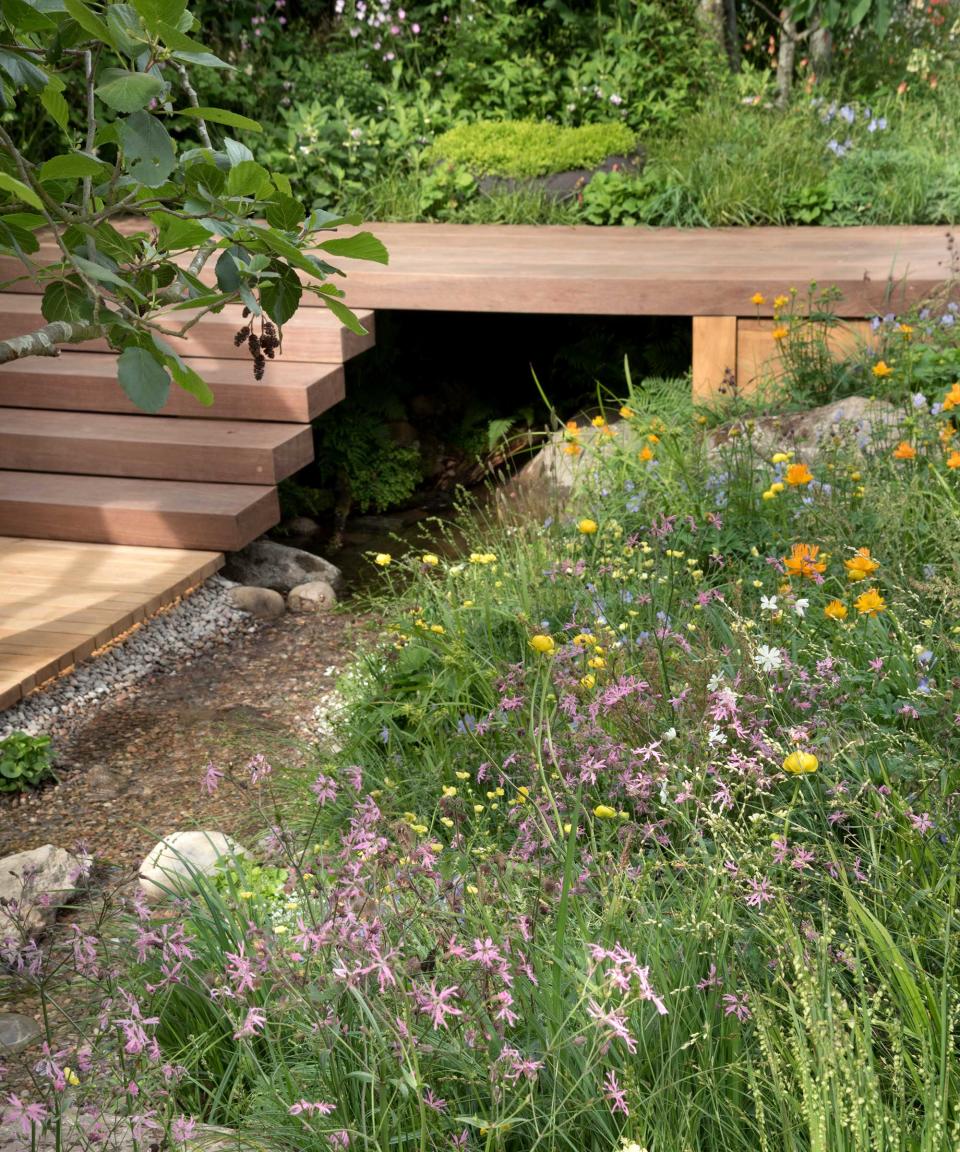 <p> Deck steps make an attractive alternative to paved ones. You could use them to link two outdoor living zones in a tiered plot or a stretch of decking to a lawn, or, as seen here, to connect a raised walkway to a lower level. </p> <p> Whether using timber or wood-effect composite, they're a smart and structured landscaping that's perfect for modern plots. In this garden, they provide a sense of definition against the beautiful, wild planting and trickling stream. </p>