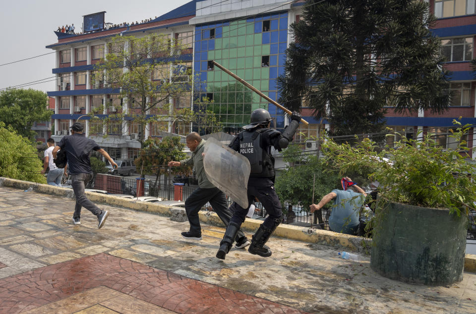 Policemen baton charge supporters of Rastriya Prajatantra Party, or national democratic party during a protest demanding a restoration of Nepal's monarchy in Kathmandu, Nepal, Tuesday, April 9, 2024. Riot police used batons and tear gas to halt thousands of supporters of Nepal's former king demanding the restoration of the monarchy and the nation's former status as a Hindu state. Weeks of street protests in 2006 forced then King Gyanendra to abandon his authoritarian rule and introduce democracy. (AP Photo/Niranjan Shrestha)