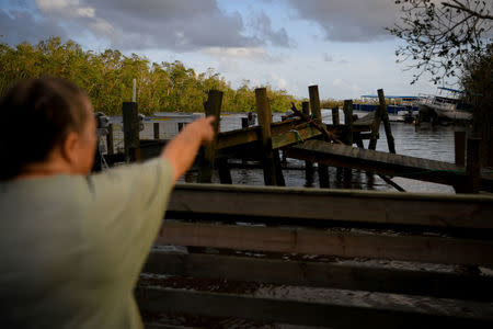 Brenda Hamilton, 62, points to her boats, resting in the trees after Hurricane Irma in Everglades City. REUTERS/Bryan Woolston