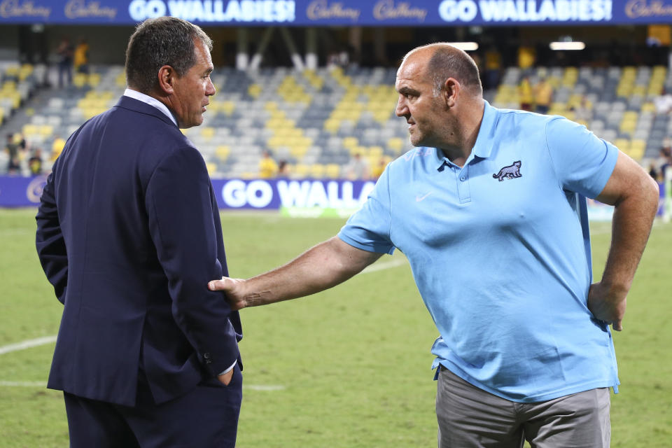 Australia's rugby coach Dave Rennie, left, talks with Argentina's coach Mario Ledesma following the Rugby Championship test match between the Pumas and the Wallabies in Townsville, Australia, Saturday, Sept. 25, 2021. (AP Photo/Tertius Pickard)