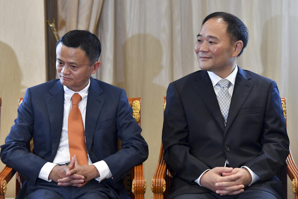 Alibaba Group Chairman Jack Ma, left, and Zhejiang Geely Holdings Chairman Li Shufu, right, attend at meeting between Malaysian Prime Minister Mahathir Mohamad and Che Jun, the Communist Party chief of Zhejiang Province, in Hangzhou in eastern China's Zhejiang Province, Saturday, Aug. 18, 2018. Mahathir is making a five-day visit to China at a time when ties between Beijing and the Southeast Asian nation are being tested by the Malaysian leader's suspension of multibillion-dollar Chinese-backed infrastructure projects. (Chinatopix via AP)