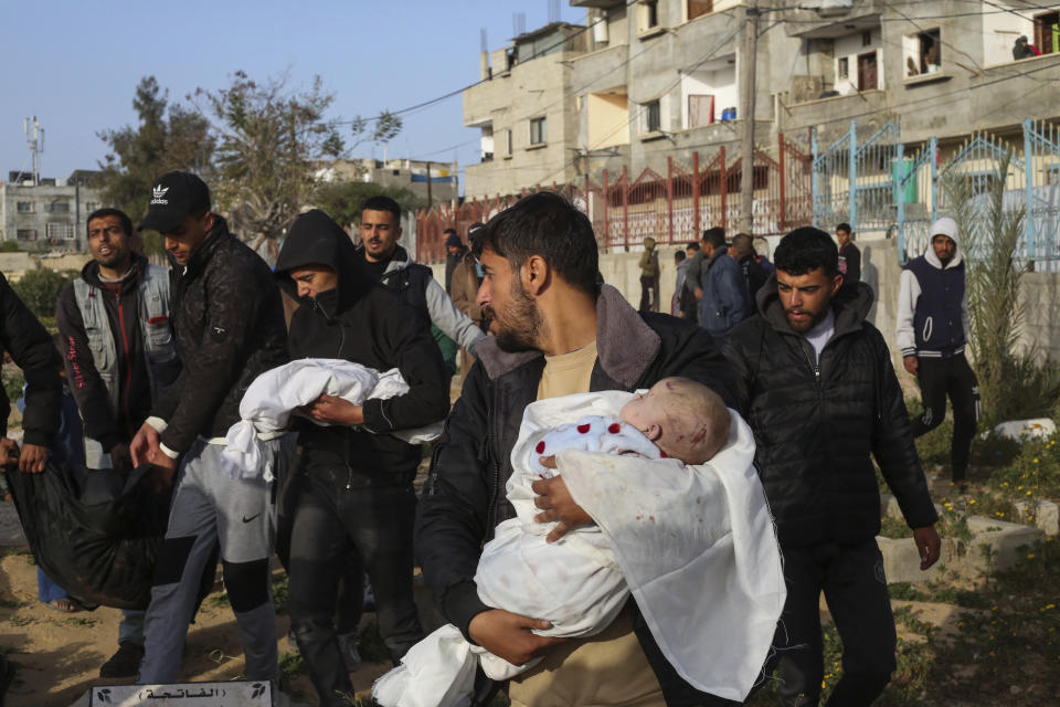 Mourners carry the bosdies of Palestinian twins, who were killed in an Israel strike on a house in Rafah, in the southern Gaza Strip, Sunday, March 3, 2024. (AP Photo/Hatem Ali)