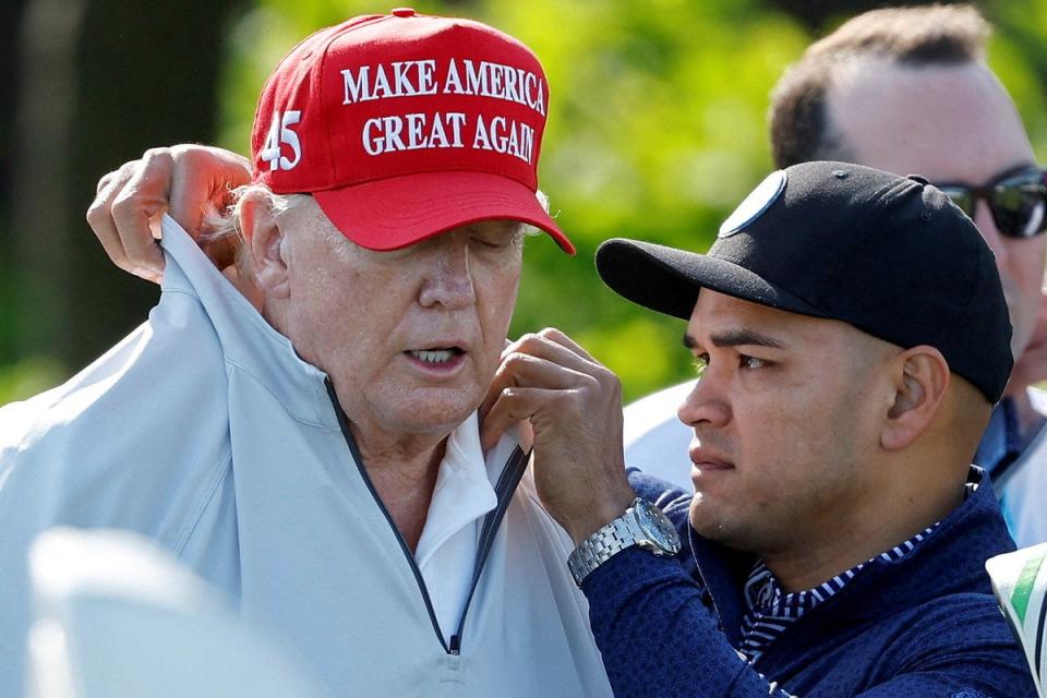 Walt Nauta, personal aide to former US president Donald Trump who faces charges of being Mr Trump’s co-conspirator in the alleged mishandling of classified documents, fixes his collar (Reuters)