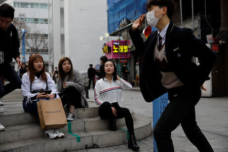 Japanese Yuuka Hasumi, 17, who wants to become a K-pop star, watches her friend's performance during their street performance in Hongdae area of Seoul, South Korea, March 21, 2019. REUTERS/Kim Hong-Ji