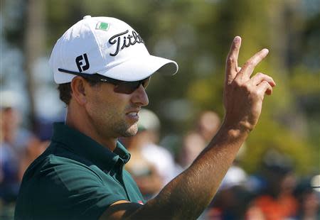 Australia's Adam Scott reacts after making his putt on the 18th hole during the first round of the 2014 Masters golf tournament at the Augusta National Golf Club in Augusta, Georgia April 10, 2014. REUTERS/Brian Snyder