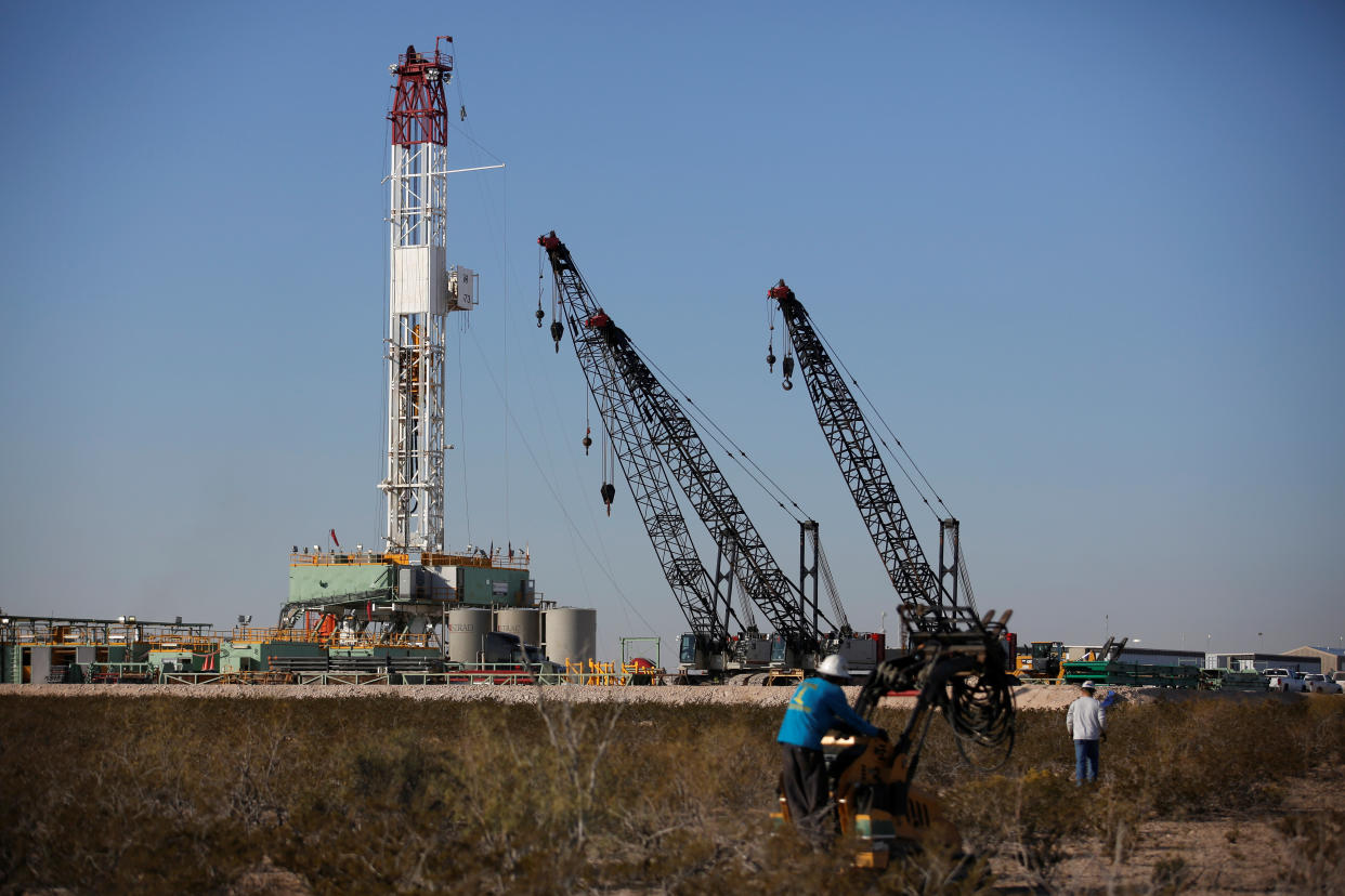 An oil worker drives a forklift truck towards a drill rig after placing some ground monitoring equipment in the vicinity of the underground horizontal drill in Loving County, Texas, U.S. November 22, 2019. Picture taken November 22, 2019.  REUTERS/Angus Mordant